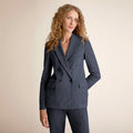 Woman wearing a gray suit on a beige background | Lead