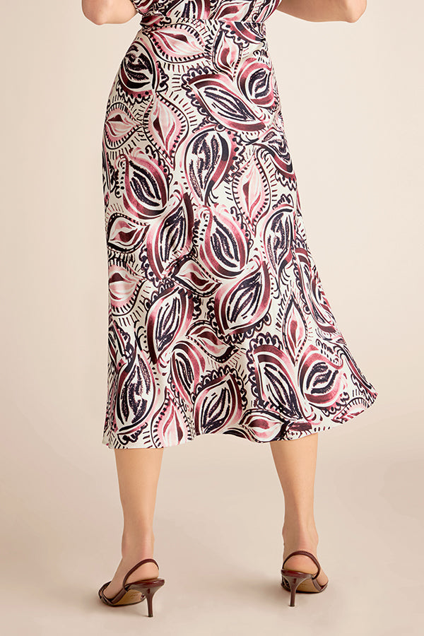 Patterned dress worn by a person on a beige background | Exclude