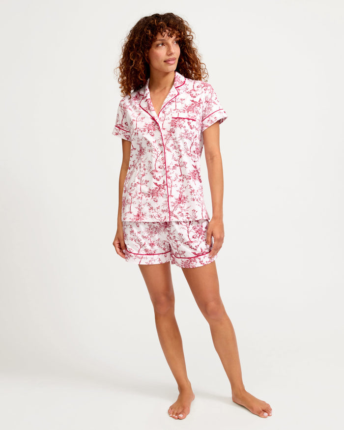 Woman wearing a floral pajama set on a white background