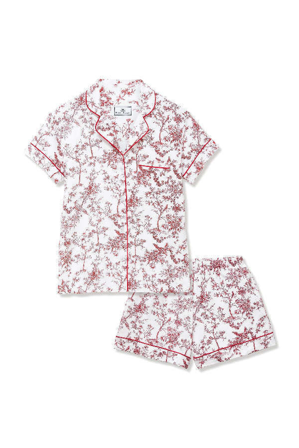 Woman wearing a pink and white floral pajama set on a plain background | Grid | Exclude