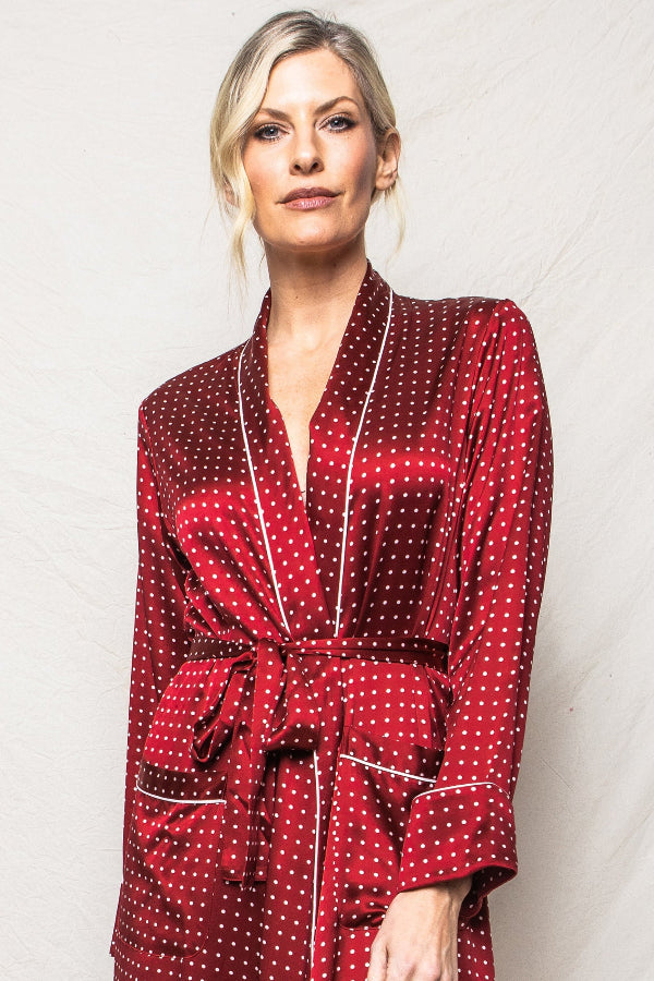 Woman wearing a red polka dot robe against a white background | Grid Hover | Exclude