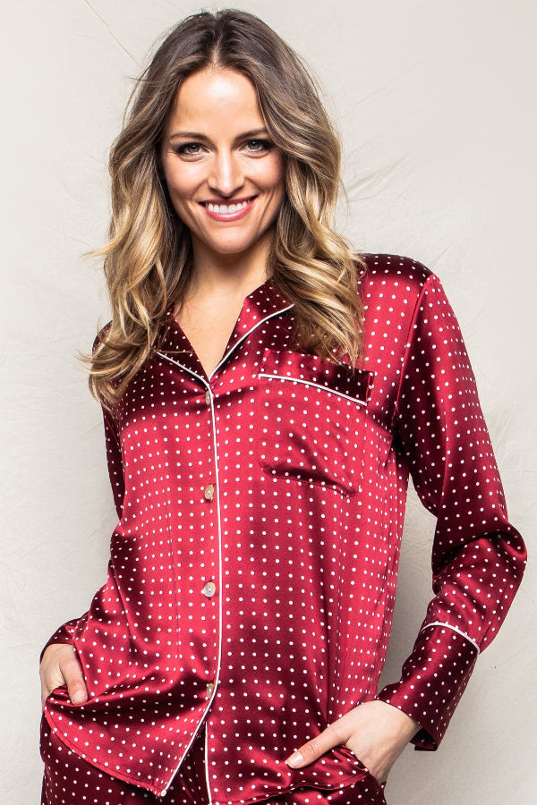 Woman wearing a red polka dot pajama set against a plain background | Grid Hover | Exclude