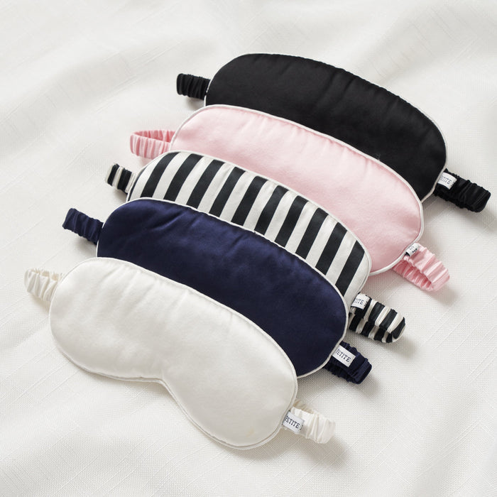 Set of five eye masks in different colors and patterns on a white background