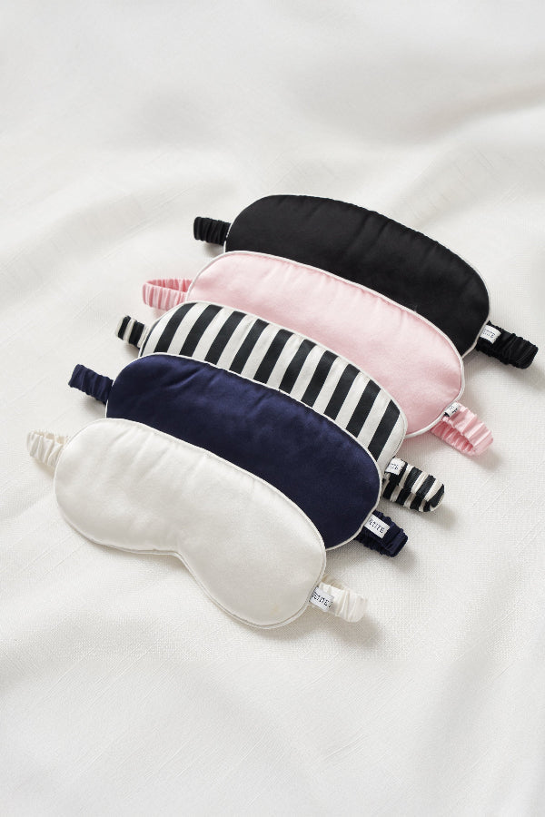 Set of five sleep eye masks in various colors on a white background | Grid Hover | Exclude