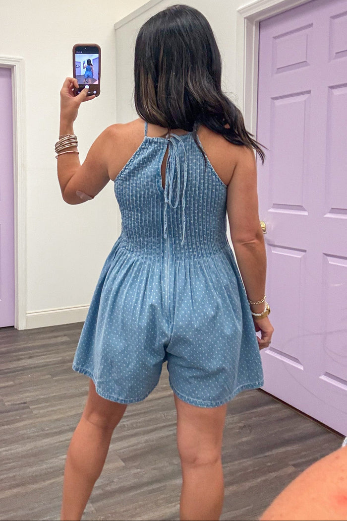 denim with small white polka dot print sleeveless halter style tie back romper