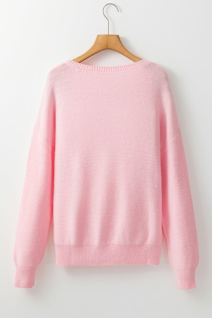 Pull tricoté rose à bords côtelés et motif de fleurs