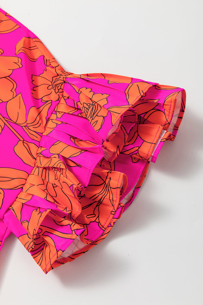 Robe fleurie rose volumineuse à manches volantées *
