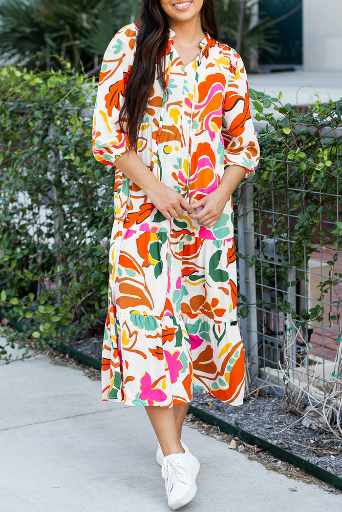 Robe longue orange à imprimé floral fendue à col en V et à plusieurs niveaux