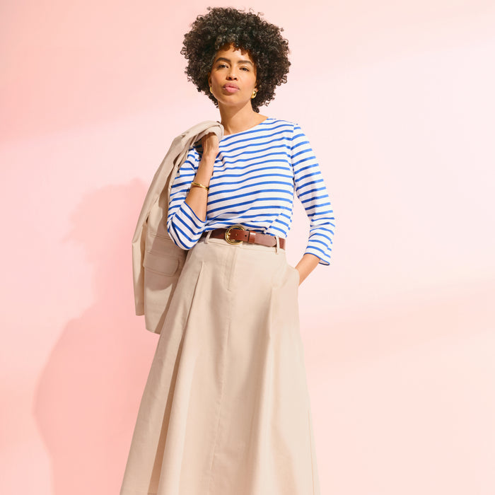front image of a woman wearing the saint james t-shirt and olia skirt in natural