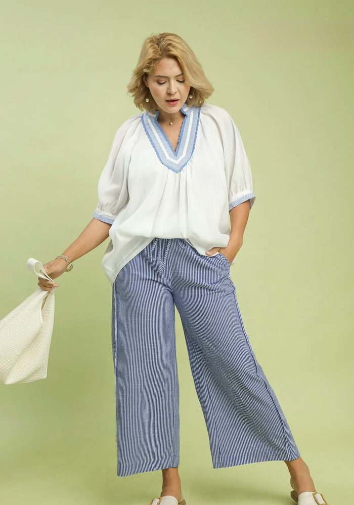 Umgee plus size blue and cream striped wide leg linen pants with frayed seam details and a flattering fit