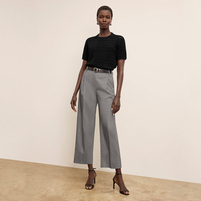Front image of a woman wearing the Sina top in black