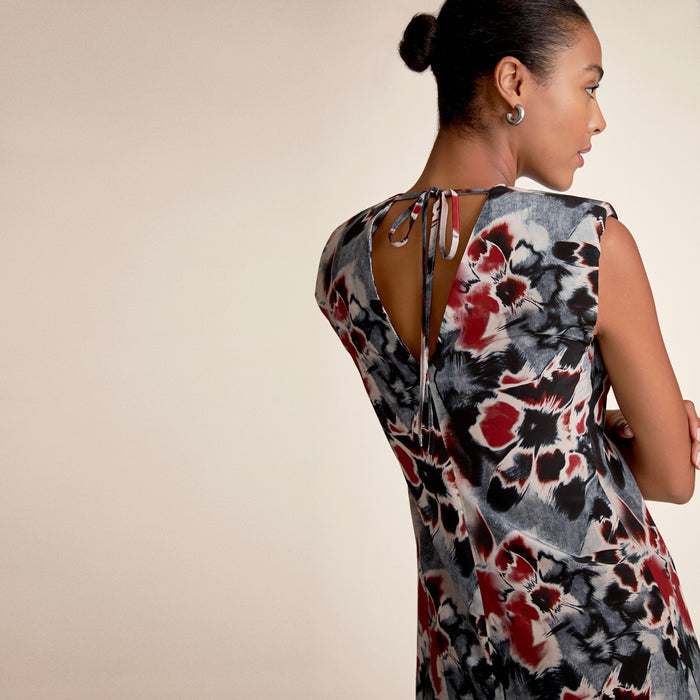 Woman wearing a floral dress with a beige background
