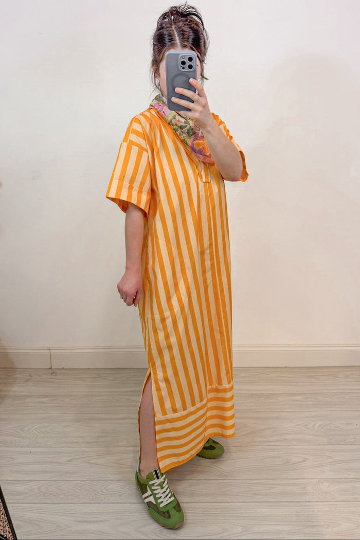orange and pale peach alternating striped midi dress with side slits at hem