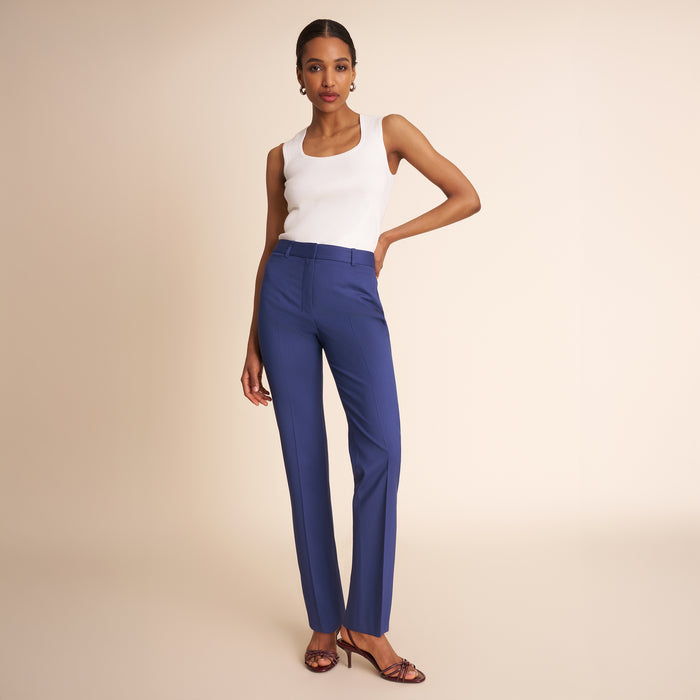 Woman in blue pants and white top.