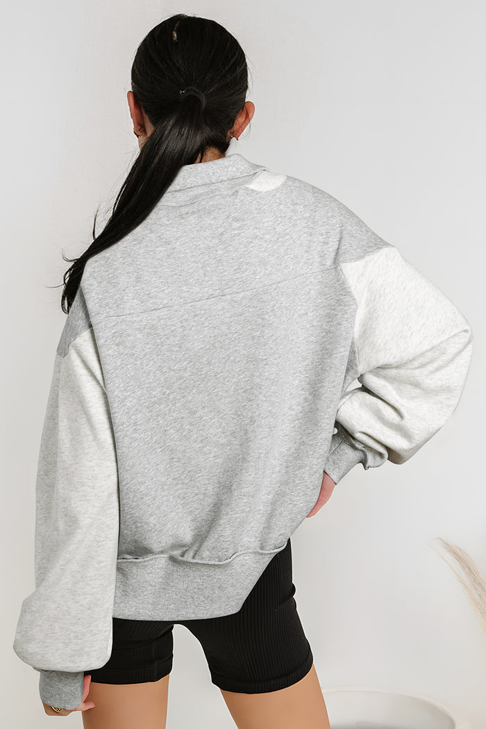 Sweat-shirt gris à demi-fermeture éclair et épaules tombantes avec fentes latérales