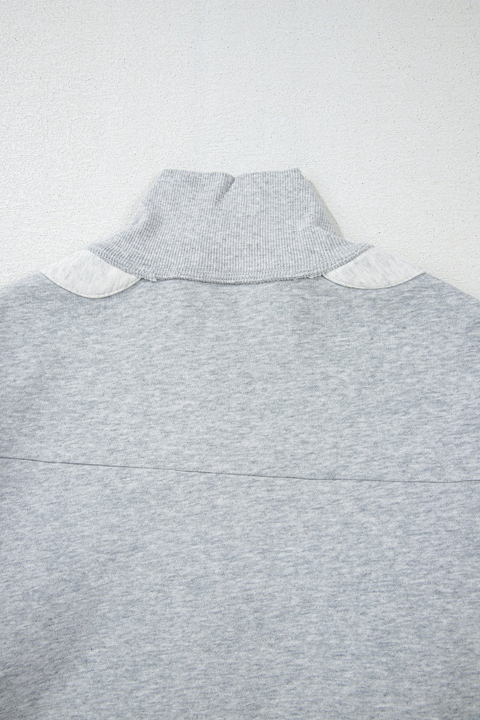 Sweat-shirt gris à demi-fermeture éclair et épaules tombantes avec fentes latérales