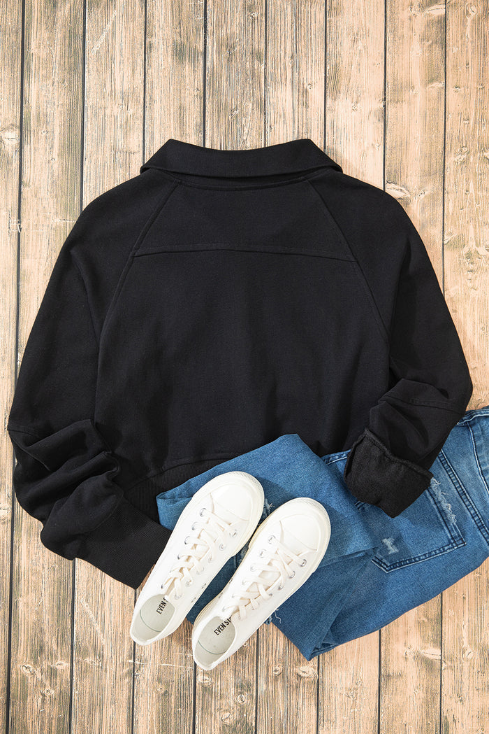 Sweat-shirt noir à col montant et poche kangourou avec fermeture éclair quart de tour