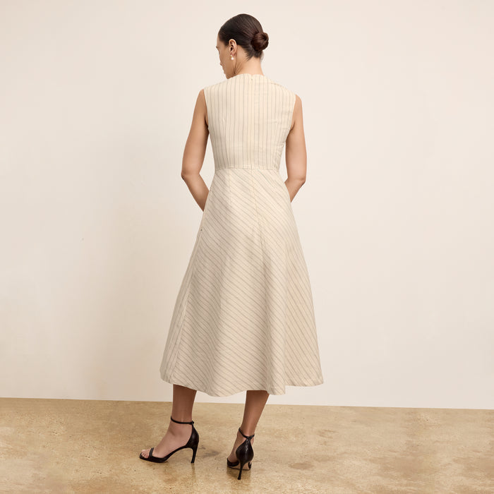 back image of a woman wearing the tati dress in linen stripe