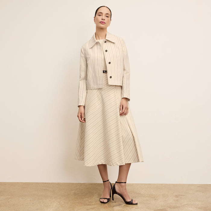front image of a woman wearing the tati dress in linen stripe