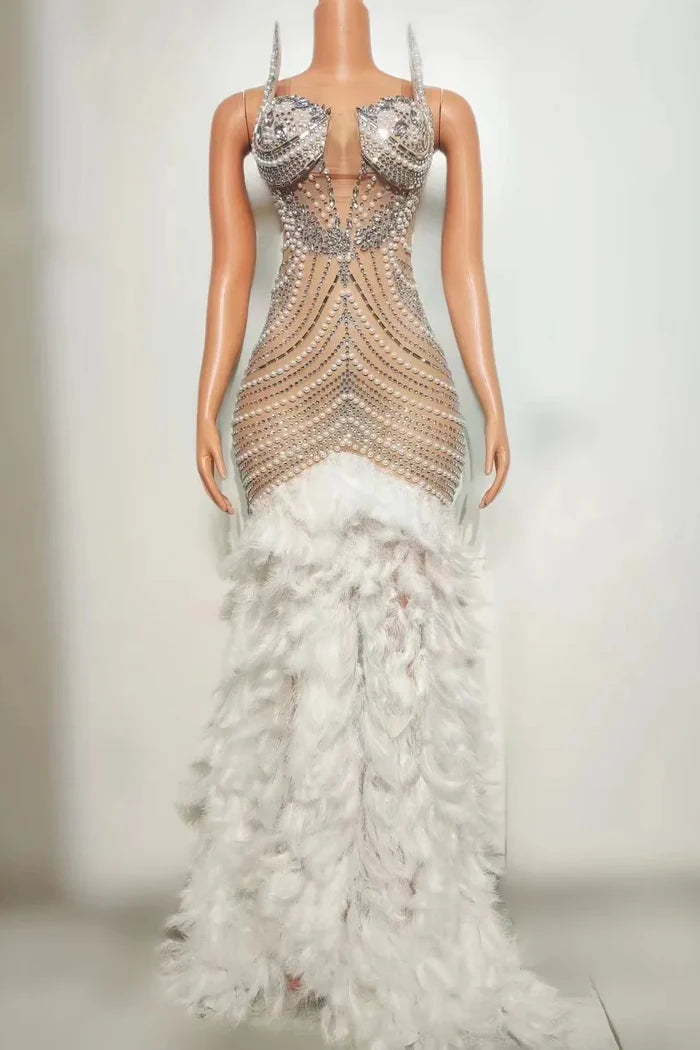 Tiana sparkly long prom dress with rhinestones, pearls, and feather details.