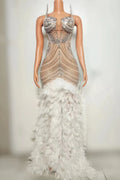 Tiana sparkly long prom dress with rhinestones, pearls, and feather details.