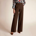 A woman wearing brown pants | Lead