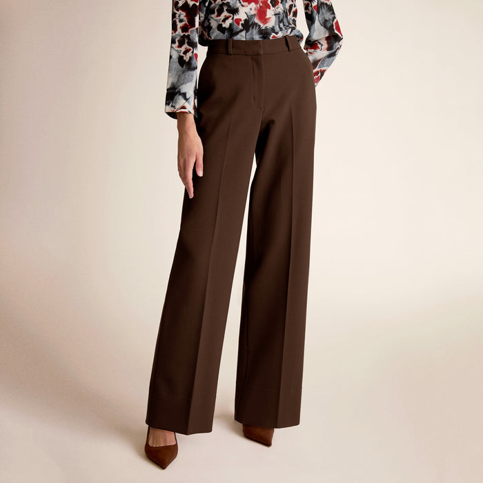 A woman wearing brown pants | Lead