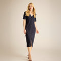Woman wearing a navy blue dress with a V-neckline and short sleeves on a beige background | Lead