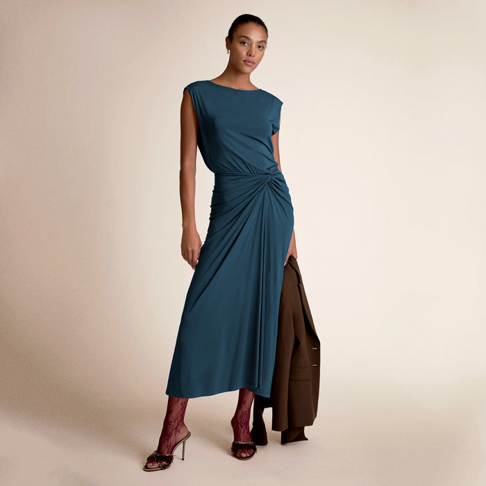Woman wearing zita dress in moroccan blue.