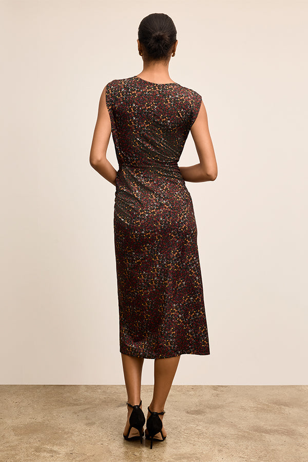 Woman wearing a patterned dress from behind on a plain background | Exclude